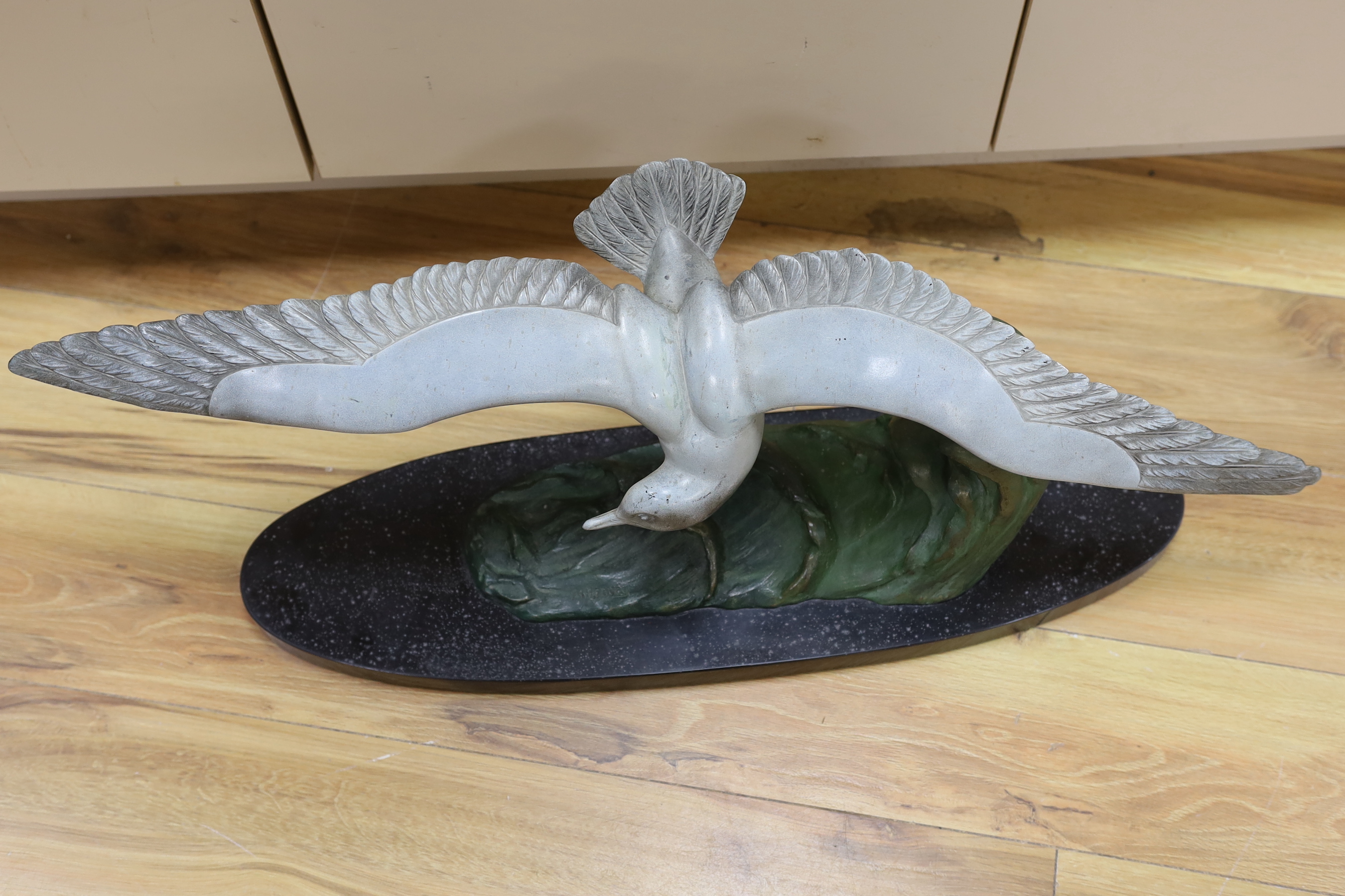 M. Leducq, a painted spelter model of a gull in flight on marble base, 86cm wingspan